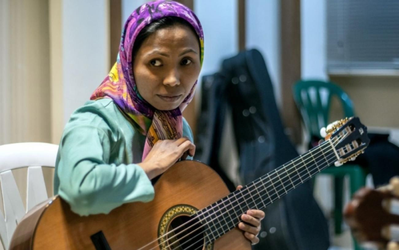 Maryam, 32, an Afgahn refugee in Iran, plays the guitar at the Sepahan Sina music centre in Esfahan.